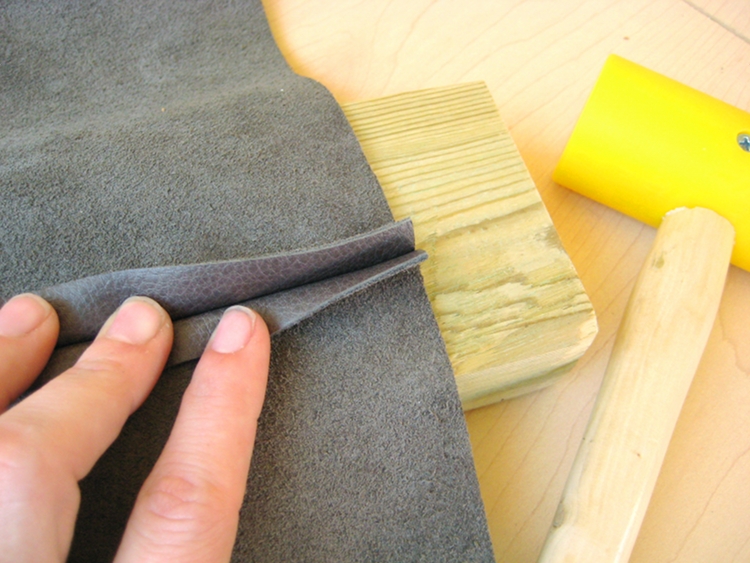 hammering a leather seam