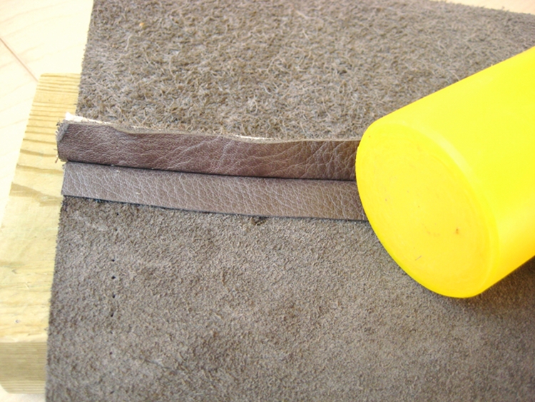 hammering a glued leather seam